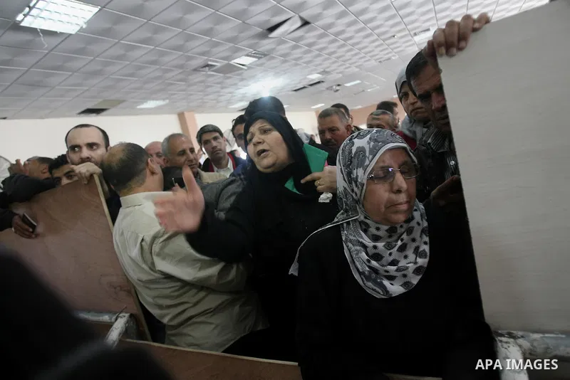Palestinians wait to cross into Egypt at the Rafah border crossing between Egypt and the southern Gaza Strip on March 30, 2014. The Gaza Strip's land border with Egypt reopened after a 50-day closure, but only for three...