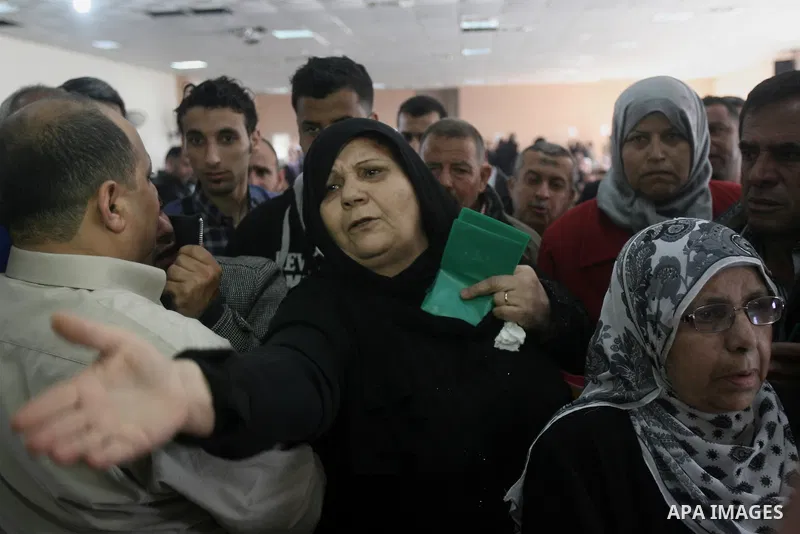 Palestinians wait to cross into Egypt at the Rafah border crossing between Egypt and the southern Gaza Strip on March 30, 2014. The Gaza Strip's land border with Egypt reopened after a 50-day closure, but only for three...