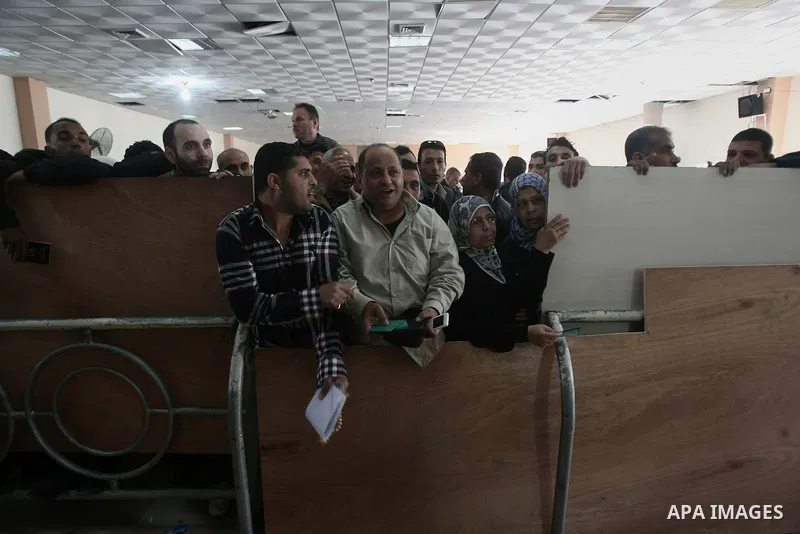 Palestinians wait to cross into Egypt at the Rafah border crossing between Egypt and the southern Gaza Strip on March 30, 2014. The Gaza Strip's land border with Egypt reopened after a 50-day closure, but only for three...