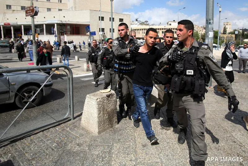 A Palestinian is arrested by Israeli Border Police during a march marking the Land Day in Jerusalem's old city, Sunday, March 29, 2014. The Land Day commemorates the Israeli government expropriation of thousands of dunam...