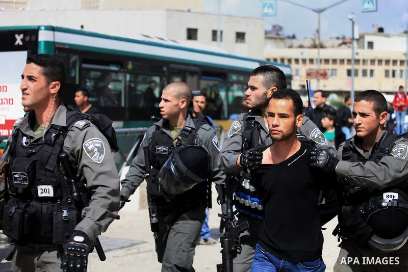 A Palestinian is arrested by Israeli Border Police during a march marking the Land Day in Jerusalem's old city, Sunday, March 29, 2014. The Land Day commemorates the Israeli government expropriation of thousands of dunam...