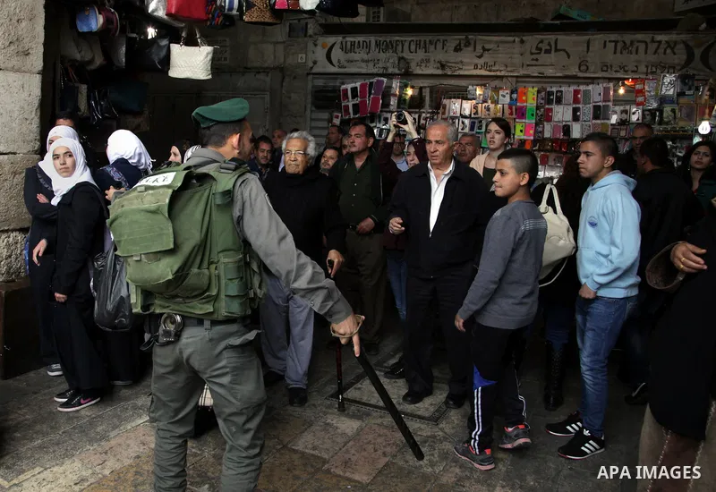 An Israeli policeman disperses Palestinian protesters during a march marking the Land Day in Jerusalem, March 29, 2014. The Land Day commemorates the Israeli government expropriation of thousands of dunams of land from P...