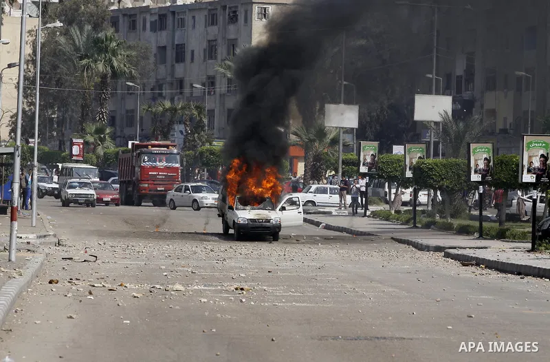 A police car set on fire by students of Al-Azhar University, who are supporters of the Muslim Brotherhood and deposed President Mohamed Mursi, is seen during clashes with riot police at the university's campus in Cairo's...