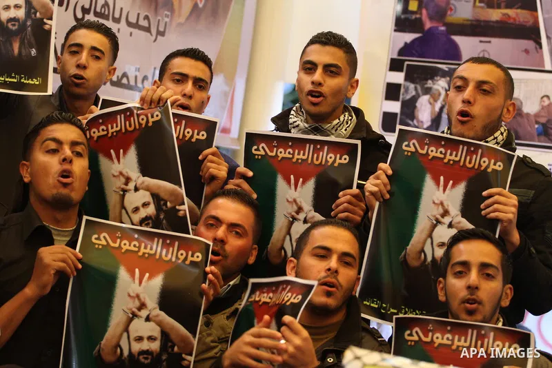 Palestinians take part in a protest demanding the release of their relatives prisoners held in Israeli jails, in front of the Red Cross office in Gaza City, on March 31, 2014. Photo by Mohammed Asad