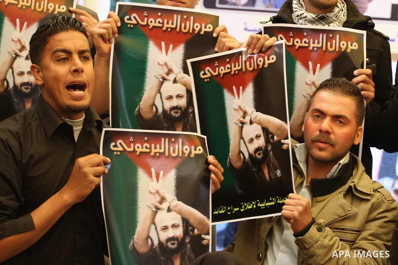 Palestinians take part in a protest demanding the release of their relatives prisoners held in Israeli jails, in front of the Red Cross office in Gaza City, on March 31, 2014. Photo by Mohammed Asad