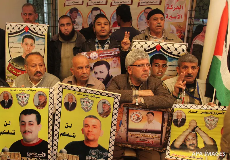 Palestinians take part in a protest demanding the release of their relatives prisoners held in Israeli jails, in front of the Red Cross office in Gaza City, on March 31, 2014. Photo by Mohammed Asad