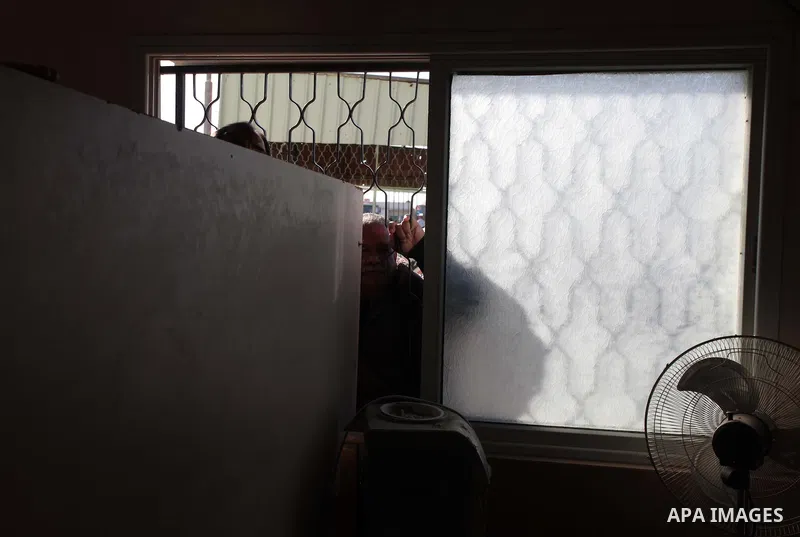 A Palestinian man hoping to cross into Egypt waits at the Rafah crossing between Egypt and the southern Gaza Strip March 31, 2014. Egyptian authorities partially reopened Rafah border crossing, Gaza's main window to the...