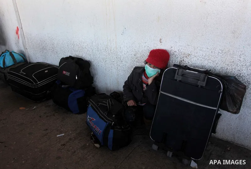 A Palestinian girl hoping to cross into Egypt waits at the Rafah crossing between Egypt and the southern Gaza Strip March 31, 2014. Egyptian authorities partially reopened Rafah border crossing, Gaza's main window to the...