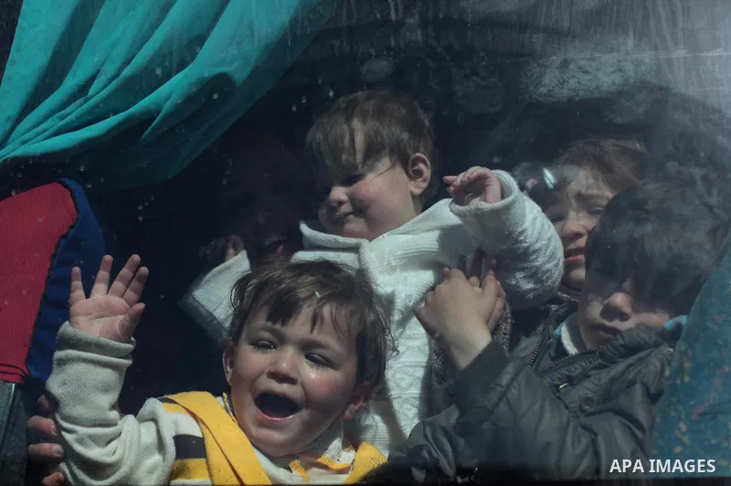 Palestinian children hoping to cross into Egypt wait inside a bus at the Rafah crossing between Egypt and the southern Gaza Strip March 31, 2014. Egyptian authorities partially reopened Rafah border crossing, Gaza's main...