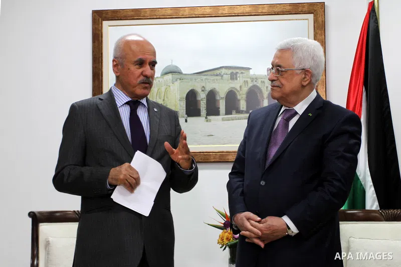 Director-General of the OPEC Fund for International Development Suleiman Herbash, speaks with Palestinian President Mahmoud Abbas during a signing ceremony with the OPEC Fund for International Development, to support Pal...