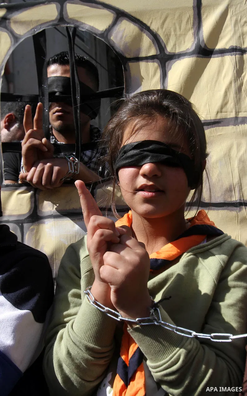 Palestinian children with hands chained take part in a protest demanding the U.S. Secretary of State John Kerry to work for release Palestinian prisoners in Israeli jails, at Balata refugee camp near the West Bank city o...