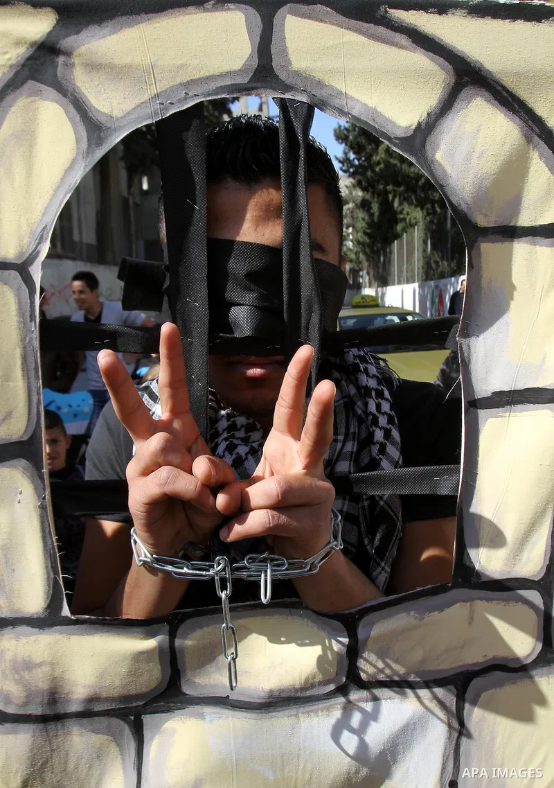 A Palestinian boy with his hands chained takes part in a protest demanding the U.S. Secretary of State John Kerry to work for release Palestinian prisoners in Israeli jails, at Balata refugee camp near the West Bank city...