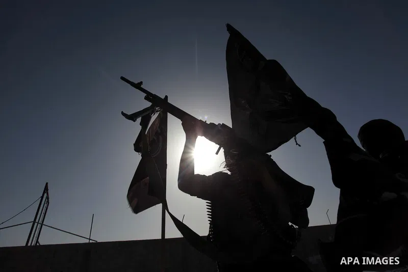 Masked militants of Al-Nasser brigades, the military wing of the Popular Resistance Committees, march with weapons during an anti-Israeli protest in Gaza City March 31, 2014. Photo by Ashraf Amra