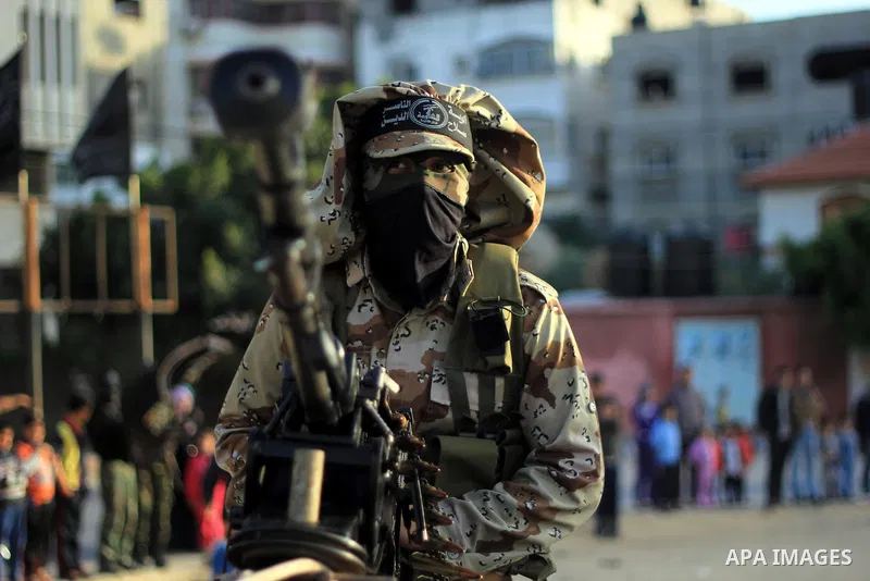 Masked militants of Al-Nasser brigades, the military wing of the Popular Resistance Committees, march with weapons during an anti-Israeli protest in Gaza City March 31, 2014. Photo by Khaled al-Sabbah