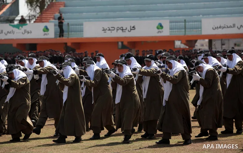 Female members of Palestinian security forces stand during a military graduation ceremony in Gaza City on April 02, 2014. 1200 officers graduated from advanced training courses that lasted one year in Gaza police academy...