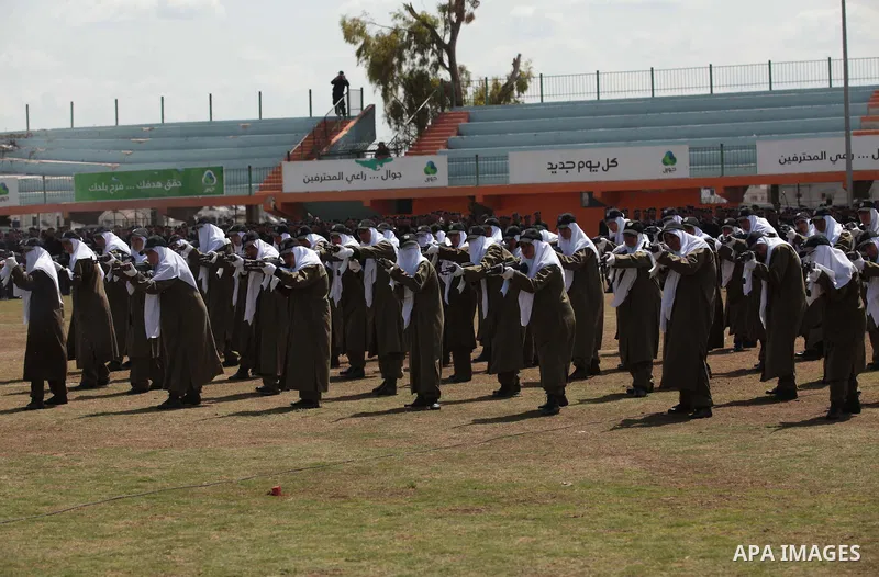 Female members of Palestinian security forces stand during a military graduation ceremony in Gaza City on April 02, 2014. 1200 officers graduated from advanced training courses that lasted one year in Gaza police academy...