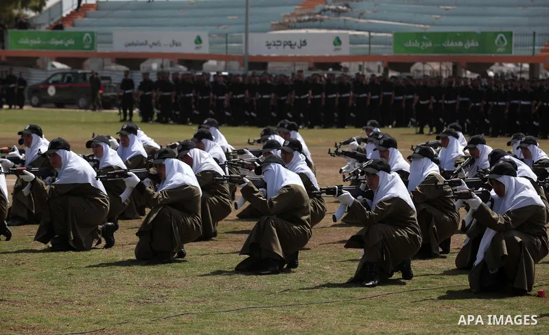 Female members of Palestinian security forces stand during a military graduation ceremony in Gaza City on April 02, 2014. 1200 officers graduated from advanced training courses that lasted one year in Gaza police academy...