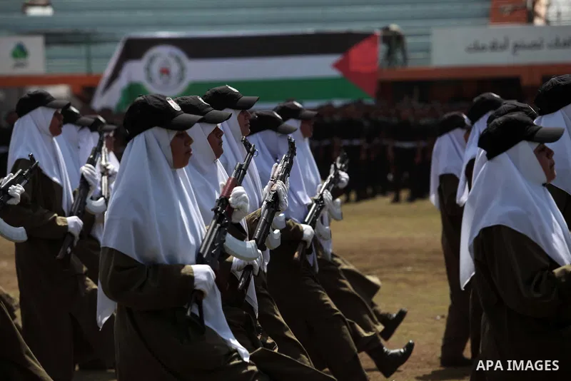 Female members of Palestinian security forces stand during a military graduation ceremony in Gaza City on April 02, 2014. 1200 officers graduated from advanced training courses that lasted one year in Gaza police academy...