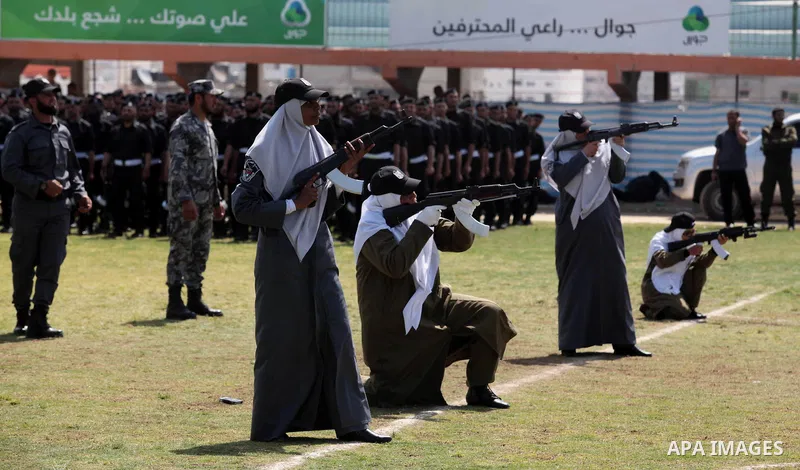 Female members of Palestinian security forces stand during a military graduation ceremony in Gaza City on April 02, 2014. 1200 officers graduated from advanced training courses that lasted one year in Gaza police academy...
