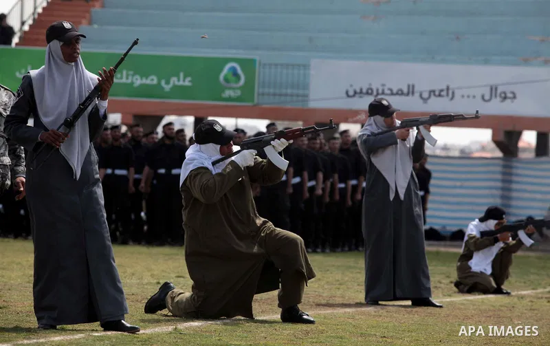 Female members of Palestinian security forces stand during a military graduation ceremony in Gaza City on April 02, 2014. 1200 officers graduated from advanced training courses that lasted one year in Gaza police academy...