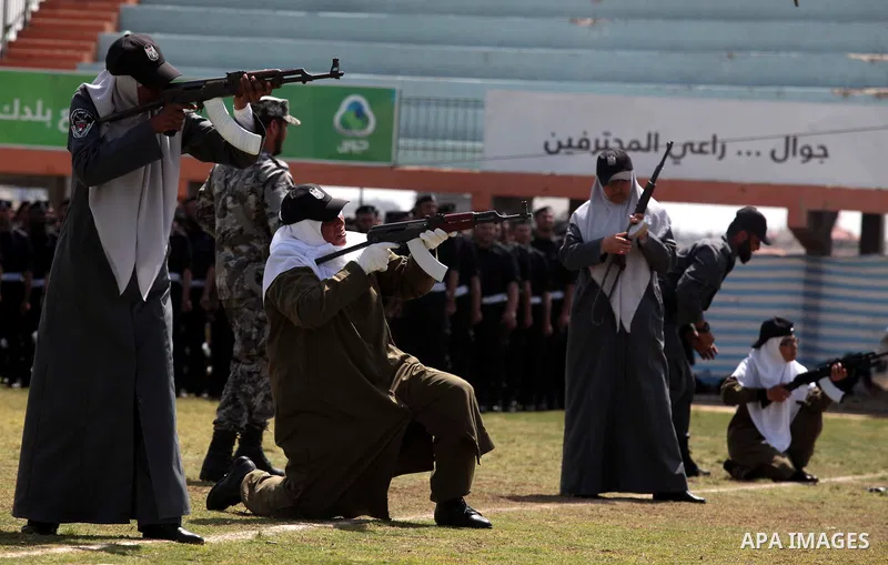 Female members of Palestinian security forces stand during a military graduation ceremony in Gaza City on April 02, 2014. 1200 officers graduated from advanced training courses that lasted one year in Gaza police academy...