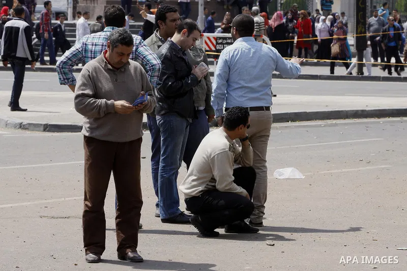 Egyptian security forces inspect the site after multiple explosions hit the area outside the main campus of Cairo University, killing at least two, in Giza, Egypt, Wednesday, April 2, 2014. The bombings targeted riot pol...