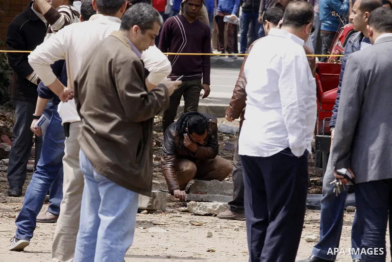 Egyptian security forces inspect the site after multiple explosions hit the area outside the main campus of Cairo University, killing at least two, in Giza, Egypt, Wednesday, April 2, 2014. The bombings targeted riot pol...