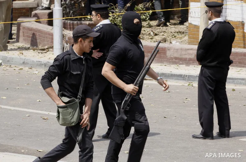 Egyptian security forces inspect the site after multiple explosions hit the area outside the main campus of Cairo University, killing at least two, in Giza, Egypt, Wednesday, April 2, 2014. The bombings targeted riot pol...