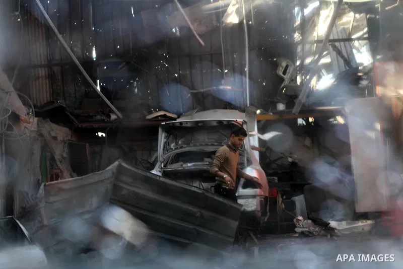 A Palestinian man inspects his workshop following an overnight Israeli air strike on Jabalia in the northern Gaza Strip, on April 4, 2014. After Israel called off the planned release of 26 Palestinian prisoners the day b...