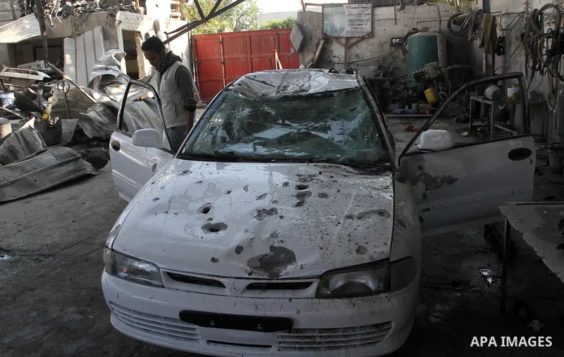 A Palestinian man inspects a damaged car following an overnight Israeli air strike on Jabalia in the northern Gaza Strip, on April 4, 2014. After Israel called off the planned release of 26 Palestinian prisoners the day...