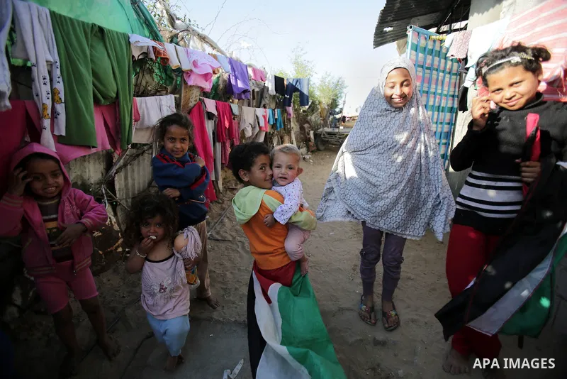 Palestinian children play outside their house, in Gaza city on April 05, 2014. Marking children's day, statistics show 50% of the population of the Gaza Strip under 18 years, 56% of them Living in poverty. Photo by Ezz a...