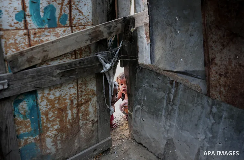 Palestinian children play outside their house, in Gaza city on April 05, 2014. Marking children's day, statistics show 50% of the population of the Gaza Strip under 18 years, 56% of them Living in poverty. Photo by Ezz a...