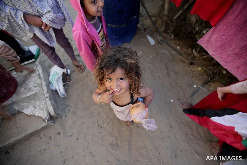 Palestinian children play outside their house, in Gaza city on April 05, 2014. Marking children's day, statistics show 50% of the population of the Gaza Strip under 18 years, 56% of them Living in poverty. Photo by Ezz a...