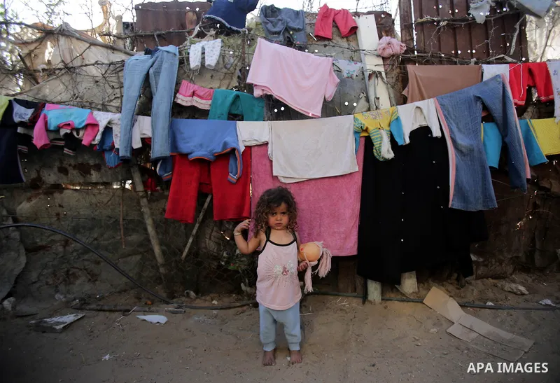 Palestinian children play outside their house, in Gaza city on April 05, 2014. Marking children's day, statistics show 50% of the population of the Gaza Strip under 18 years, 56% of them Living in poverty. Photo by Ezz a...