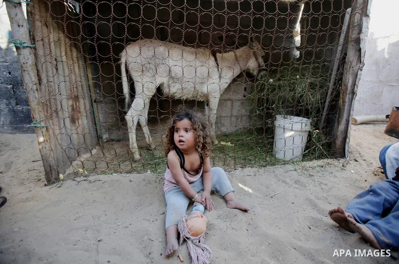 Palestinian children play outside their house, in Gaza city on April 05, 2014. Marking children's day, statistics show 50% of the population of the Gaza Strip under 18 years, 56% of them Living in poverty. Photo by Ezz a...