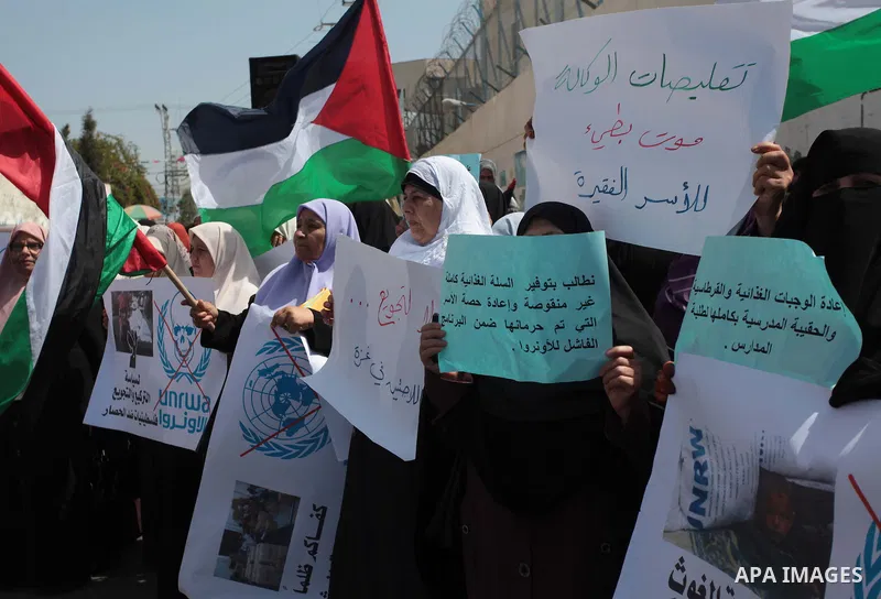 Palestinian women take part in a protest against the decision made by the United Nations Relief and Works Agency (UNRWA) to reduce food aid delivered to the Gaza Strip in front of the UNRWA headquarters in Gaza City on A...