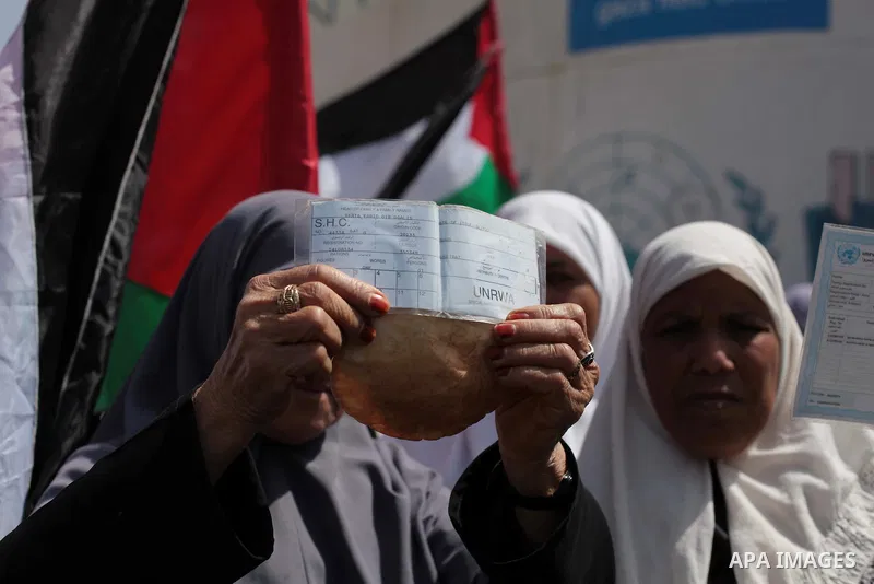 Palestinian women take part in a protest against the decision made by the United Nations Relief and Works Agency (UNRWA) to reduce food aid delivered to the Gaza Strip in front of the UNRWA headquarters in Gaza City on A...