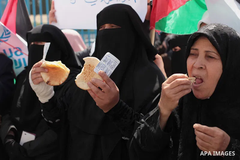 Palestinian women take part in a protest against the decision made by the United Nations Relief and Works Agency (UNRWA) to reduce food aid delivered to the Gaza Strip in front of the UNRWA headquarters in Gaza City on A...