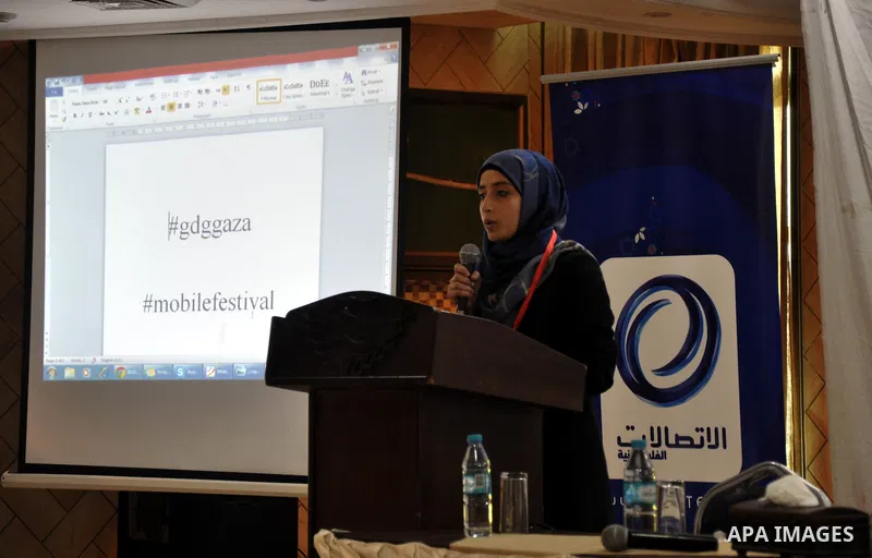 Palestinian students attend a conference of developing applications for smart phones that are running under Android operating system, in Gaza City on April 04, 2014. Students display during the meeting which was organize...