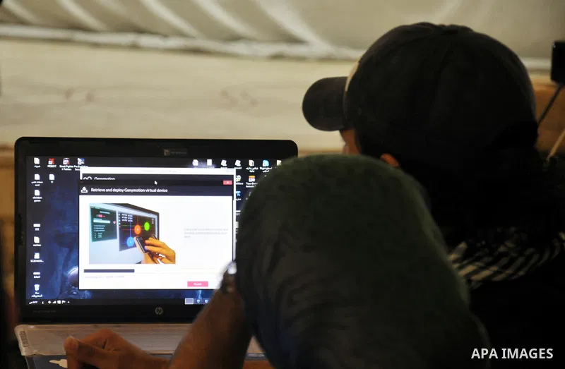 Palestinian students attend a conference of developing applications for smart phones that are running under Android operating system, in Gaza City on April 04, 2014. Students display during the meeting which was organize...