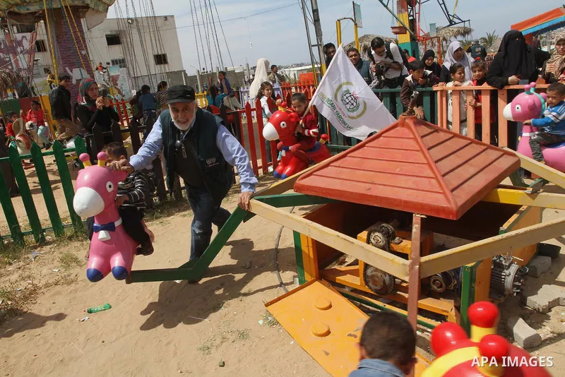 Palestinian children play during a rally marking "World Orphan's Day" organized by the Turkish humanitarian relief IHH, in Gaza City, on April 13, 2014. Photo by Mohammed Asad