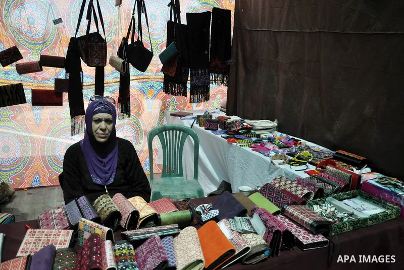 Palestinians participate in the opening of an exhibition of the national products at the Islamic University in Gaza city on April 13, 2014. Photo by Mohammed Talatene