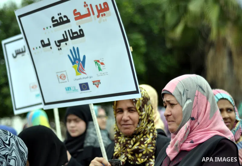 Palestinian women hold banners during a protest to demand their rights in Gaza city on April 15, 2014. Photo by Mohammed Talatene