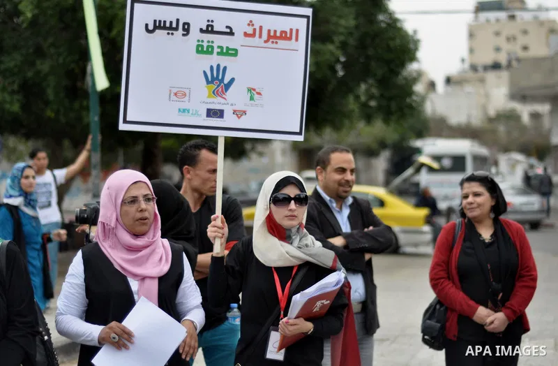 Palestinian women hold banners during a protest to demand their rights in Gaza city on April 15, 2014. Photo by Mohammed Talatene