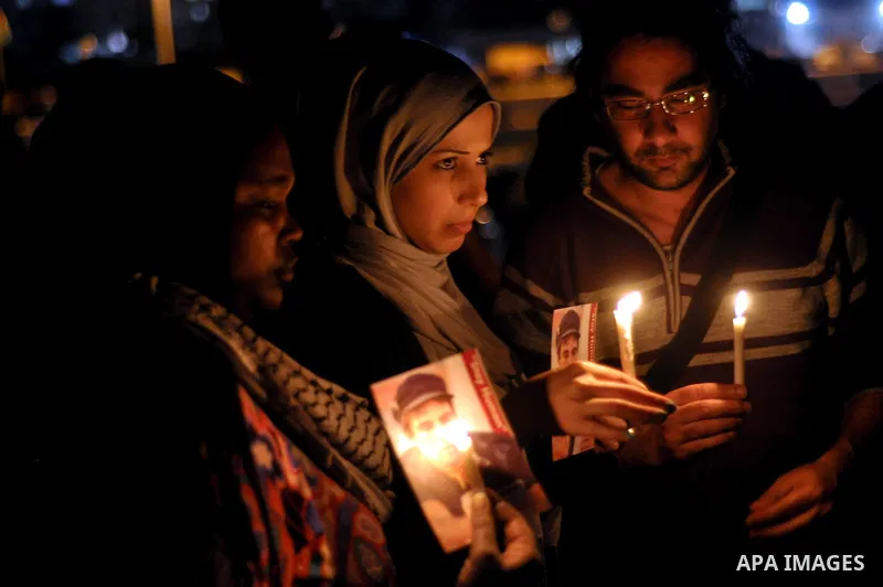 Palestinian activists light candles and hold pictures of Italian human rights activist Vittorio Arrigoni during a rally marking the third anniversary of his murder, in Gaza City on April 15, 2014. Arrigoni, a 36-year-old...