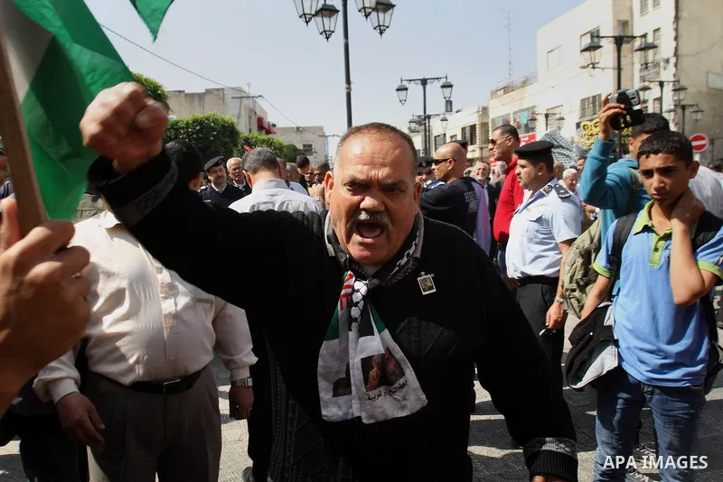 Palestinians chant slogans in a rally marking Palestinian Prisoner's Day in the West Bank city of Tulkarem on April 17, 2014. Israel holds some 5,000 Palestinians it accuses of committing or planning violence against it....