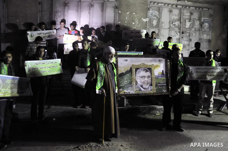 Palestinian Hamas supporters hold placards and pictures of former Hamas leader Abdel Aziz al-Rantissi during a rally marking the tenth anniversary of his assassination, in Gaza City on April 17, 2014. Rantisi was Hamas's...