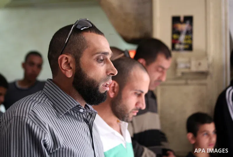 Palestinian muslims pray in front of Israeli policemen (not seen) as they prevent them from entering the Al-Aqsa mosque compound, in the Old City of Jerusalem on April 18, 2014. Israeli authorities on Friday prevented Pa...