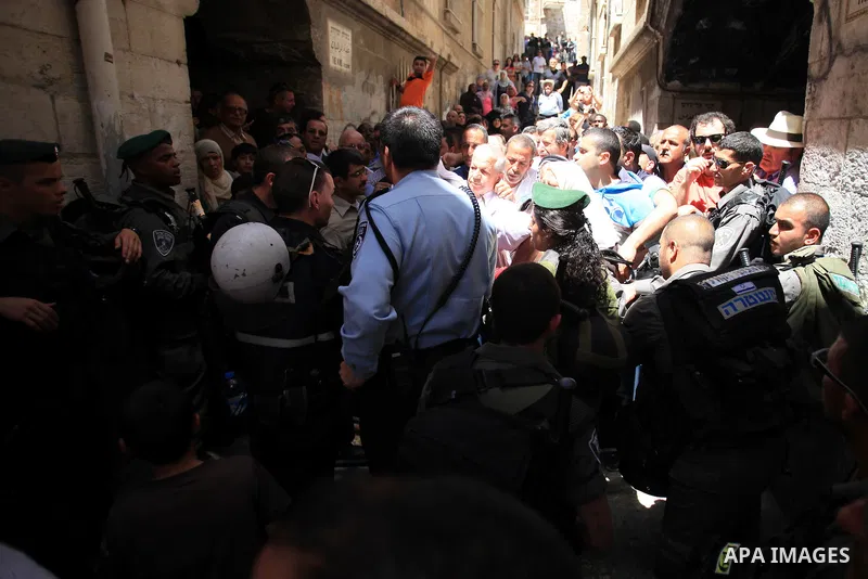 Israeli policemen prevent Palestinians from entering the Al-Aqsa mosque compound in the Old City of Jerusalem on April 18, 2014. Israeli authorities on Friday prevented Palestinians, who are less than 50 years old, from...