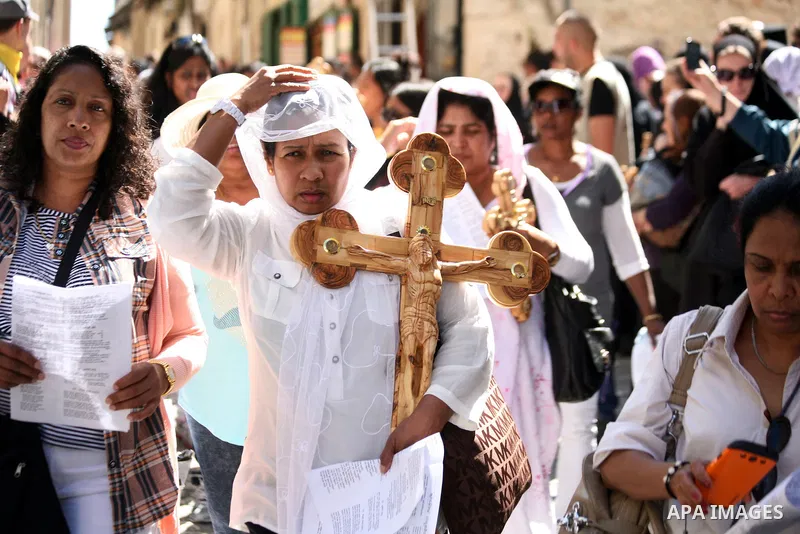 Christian Orthodox pilgrims participate in a procession marking Good Friday on April 18, 2014 in Jerusalem's old city. Thousands of Christian pilgrims take part in processions along the route where, according to traditio...